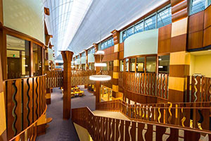 Library. Wooden banisters that line the ramps and serve as second-floor railings are carved with a unique, swirling design.