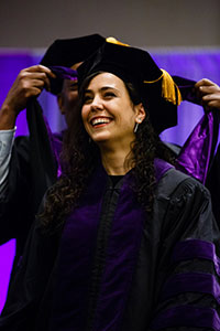 A female graduate smiles during the commencement.