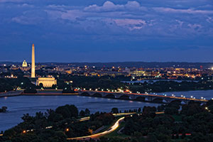Aerial view of Washington, DC, at night. The Washington Monument is in view.