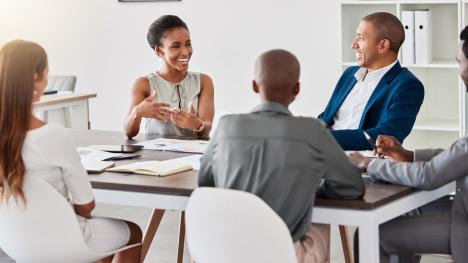 Group of law professionals conversing at conference table