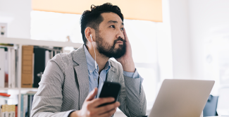 Admission professional listening to the podcast at a laptop