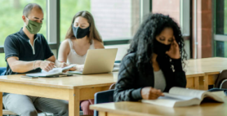 2020 - full color photo of law students reading at desks reading textbooks