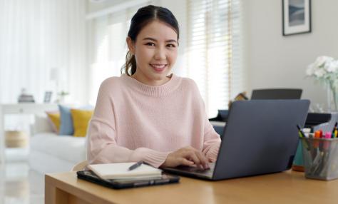 Woman typing on her laptop