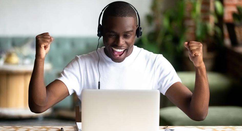 Test taker flexing his arms in front of a laptop