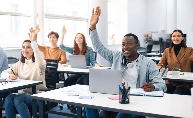 Law students in class, with one student raising their hand