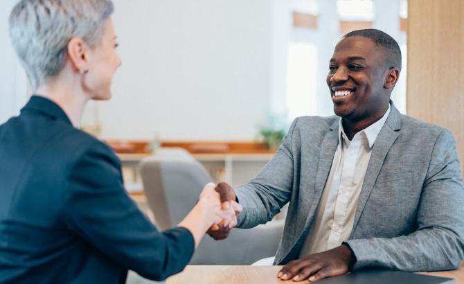 Law school graduate shaking hands with potential employer