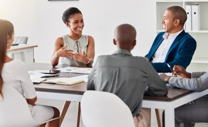 Group of legal professionals conversing at a table