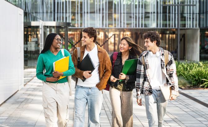 Group of students walking and talking on campus